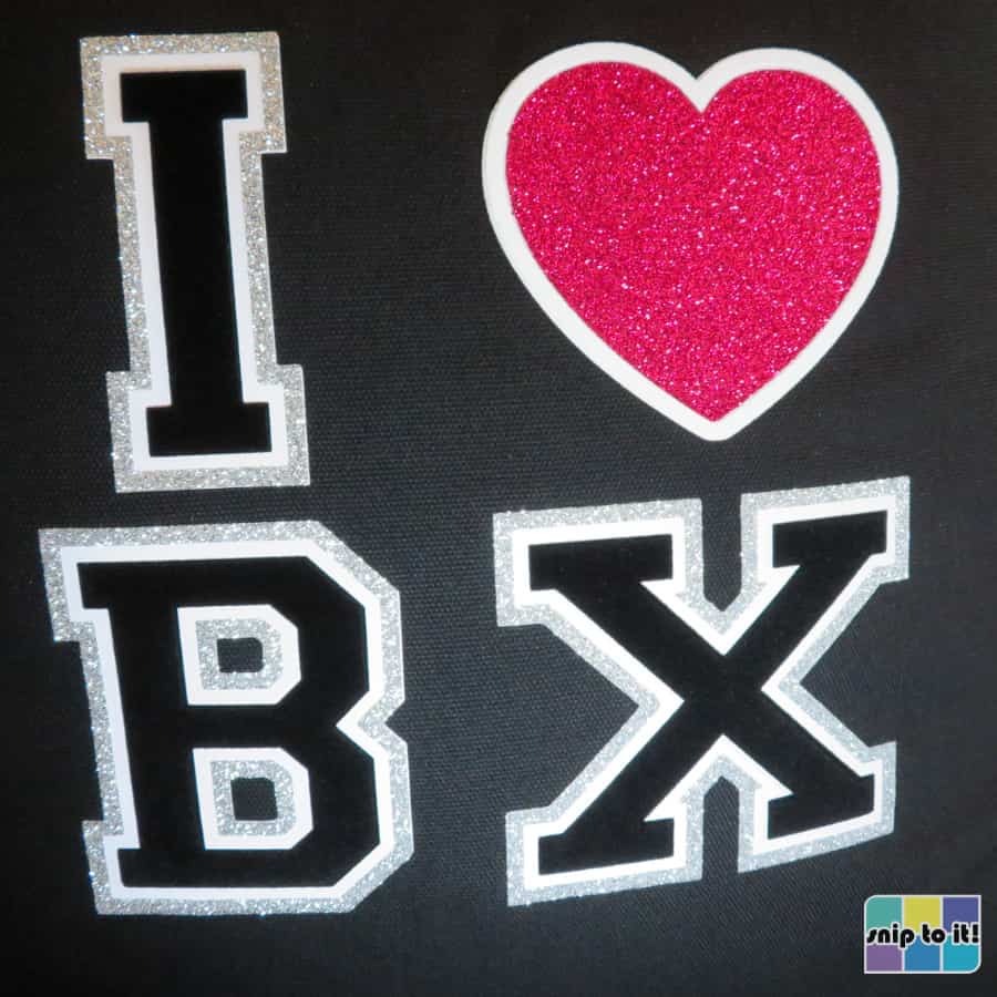 finished, pressed "I love bronx" design on pillow cover, showing glitter borders around stripflock letters and flock border around a glitter heart