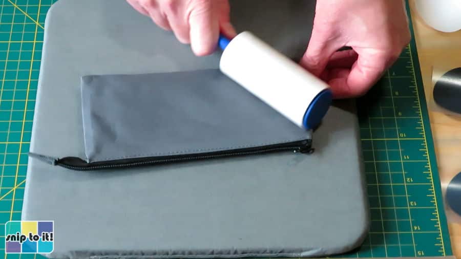 lint roller being used to clean off base material before pressing