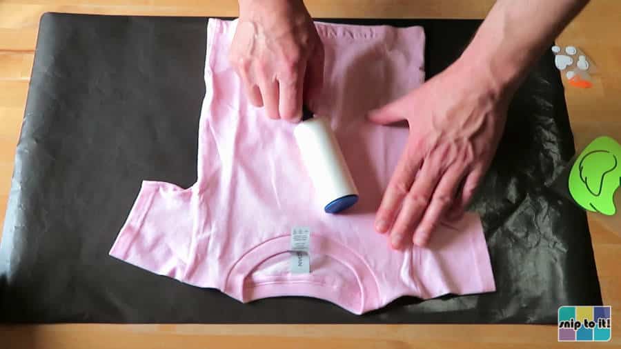 picture showing preparation of shirt for pressing, using a lint roller