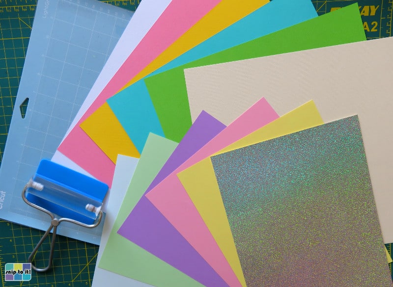 photo of the cardstock, cricut mat, brayer and squeegee used to make our no-glue insert cards