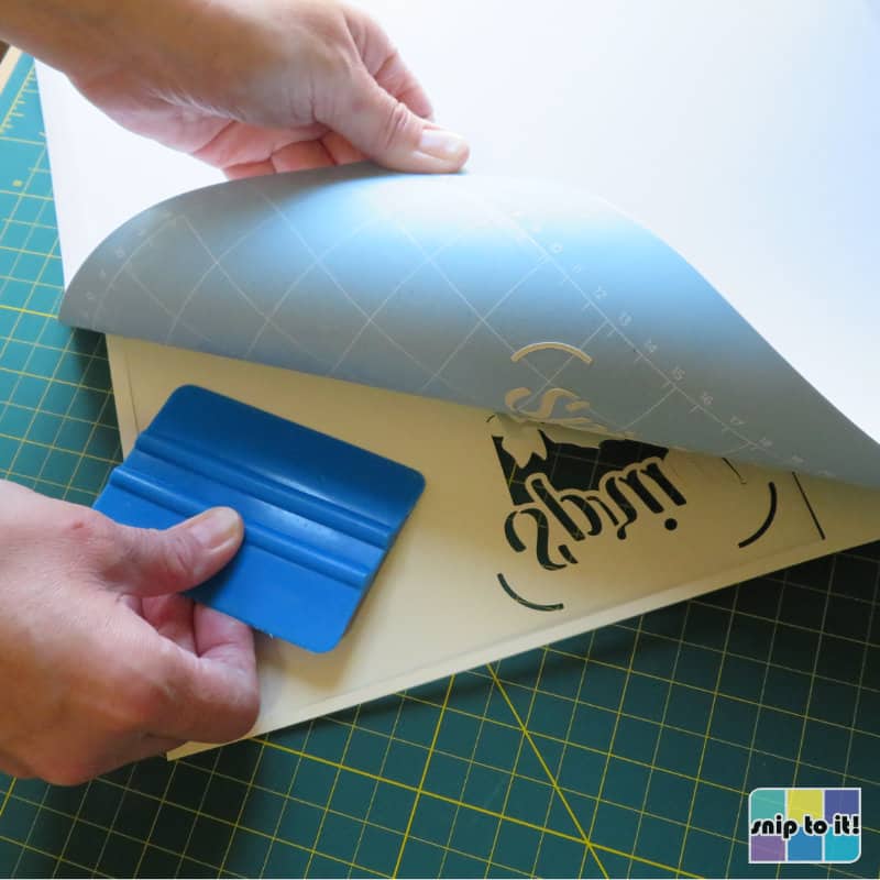 photo of how to remove cut cardstock from the mat, turning the mat over and using a squeegee