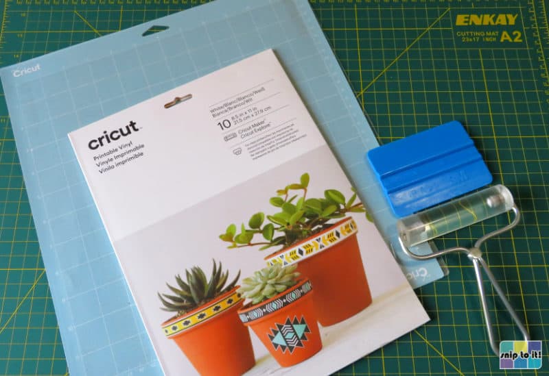 Cricut printable vinyl (white) with cutting mat, brayer and squeegee used to make this sticker project