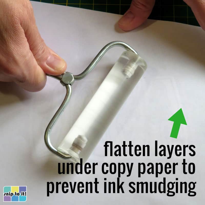 photo of using brayer to flatten all layers of the mama card together