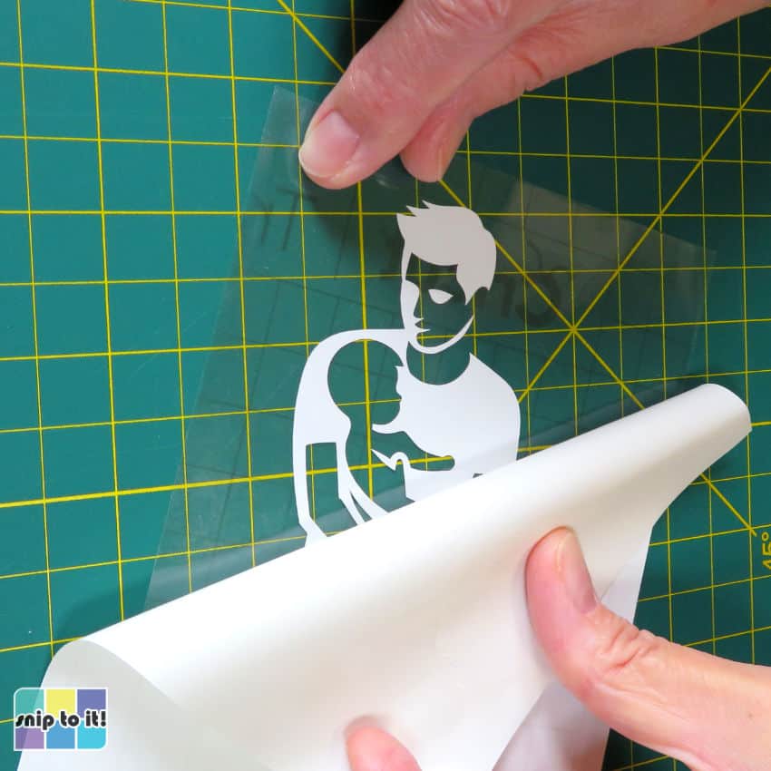 closeup image of adhesive vinyl applied to transfer tape sheet and the backer being peeled off