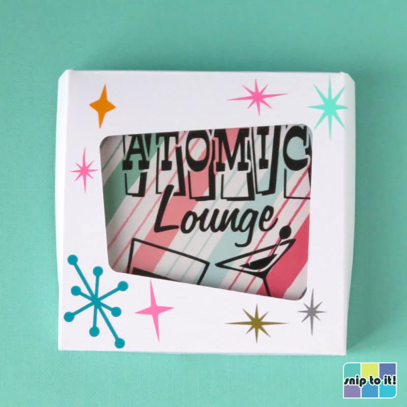gift box for mid century coaster set, featuring a classic skewed rectangle cutout window and decorated with vinyl starbursts of various colors