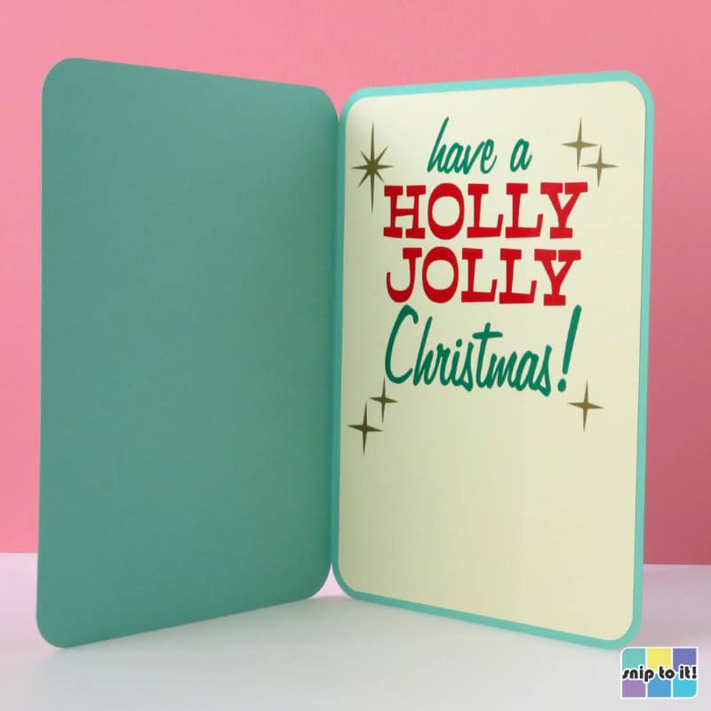 inside of HO HO HO vintage card, showing the "have a holly jolly christmas" sentiment in vinyl lettering with starbursts