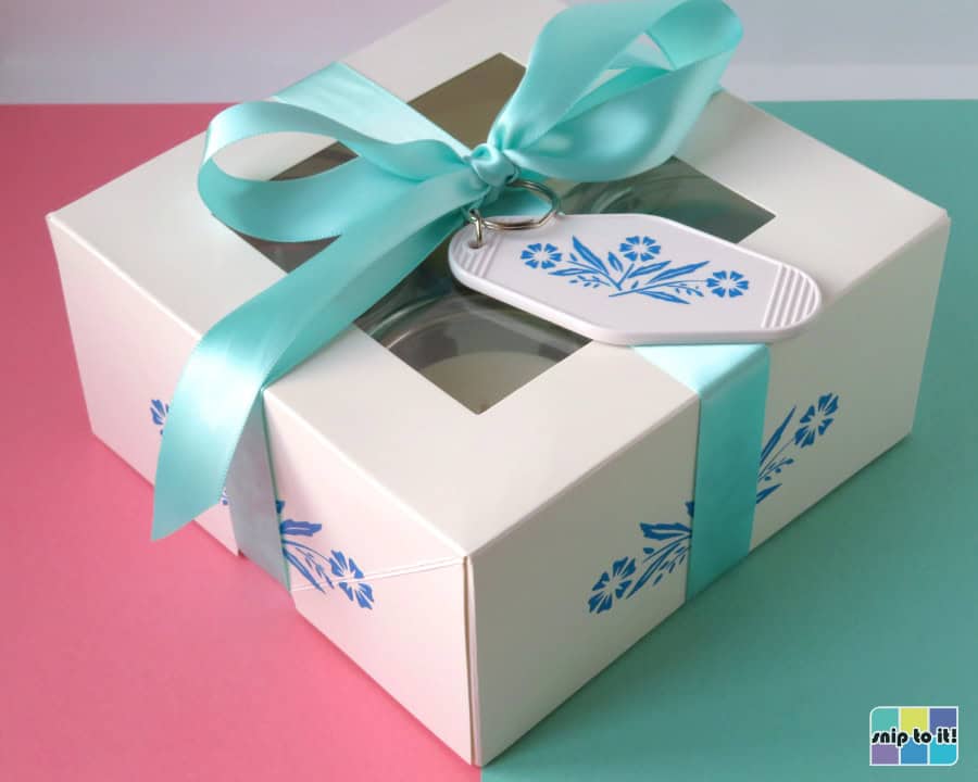 gift box of 4 votive candles decorated with blue cornflower pattern and tied with a turquoise bow