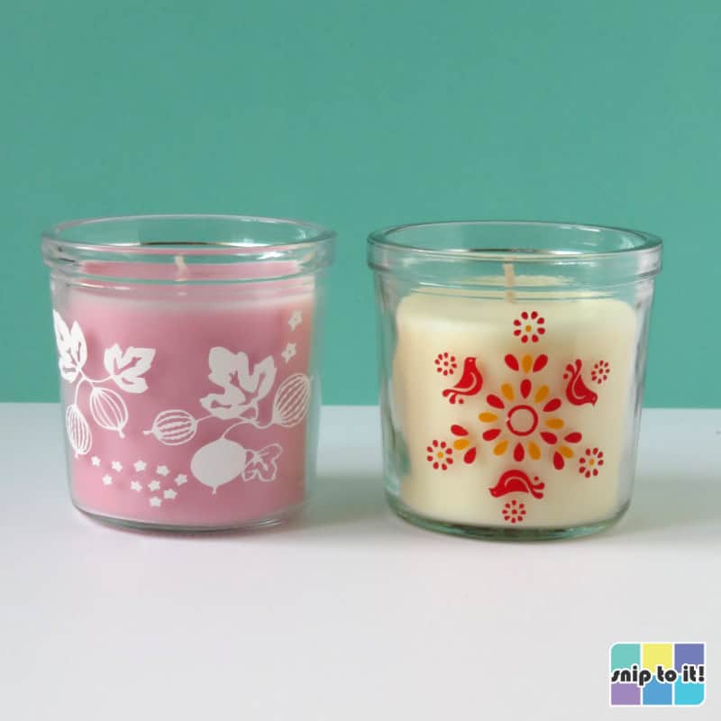 photo of pink votive candle with white vinyl decoration in pyrex pink gooseberry pattern, next to white votive candle decorated with red and yellow vinyl in pyrex friendship pattern