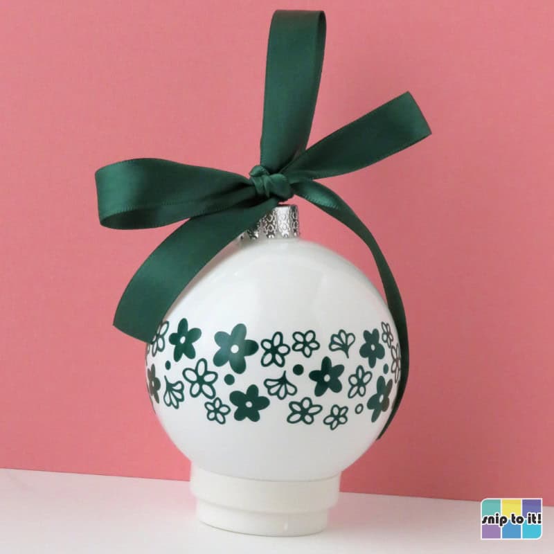 white christmas bauble decorated with green vinyl in pyrex spring blossom pattern