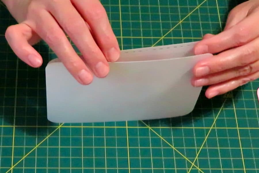 photo of lining up layers for recessed text eclipse card by standing layers up and tapping them on the mat to align along the bottom and sides