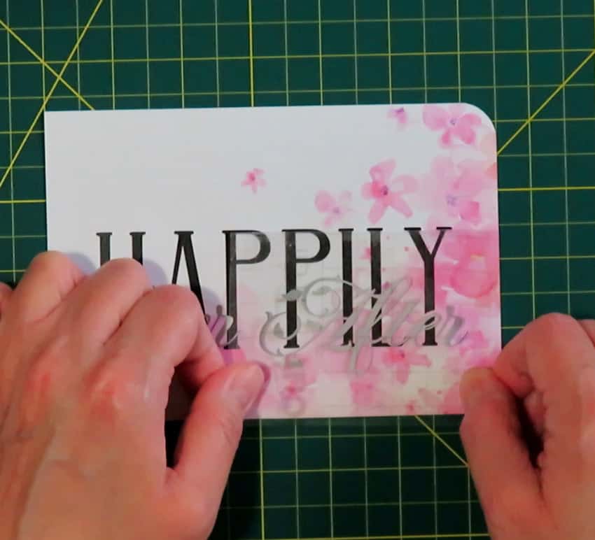 photo of top script text  "After" being transferred overtop of HAPPILY. Placement depends on fitting After into the base text like a puzzle piece, nestling it into the gaps in the base text