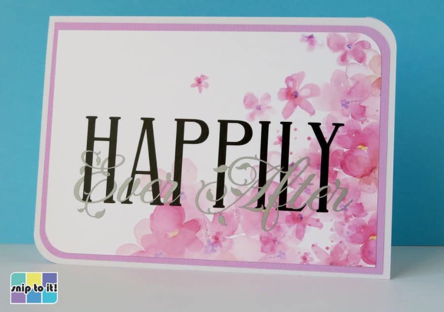 completed HAPPILY Ever After intertwined text wedding congratulations card, showing design added to a panel with watercolor cherry blossoms and then adhered to a card base
