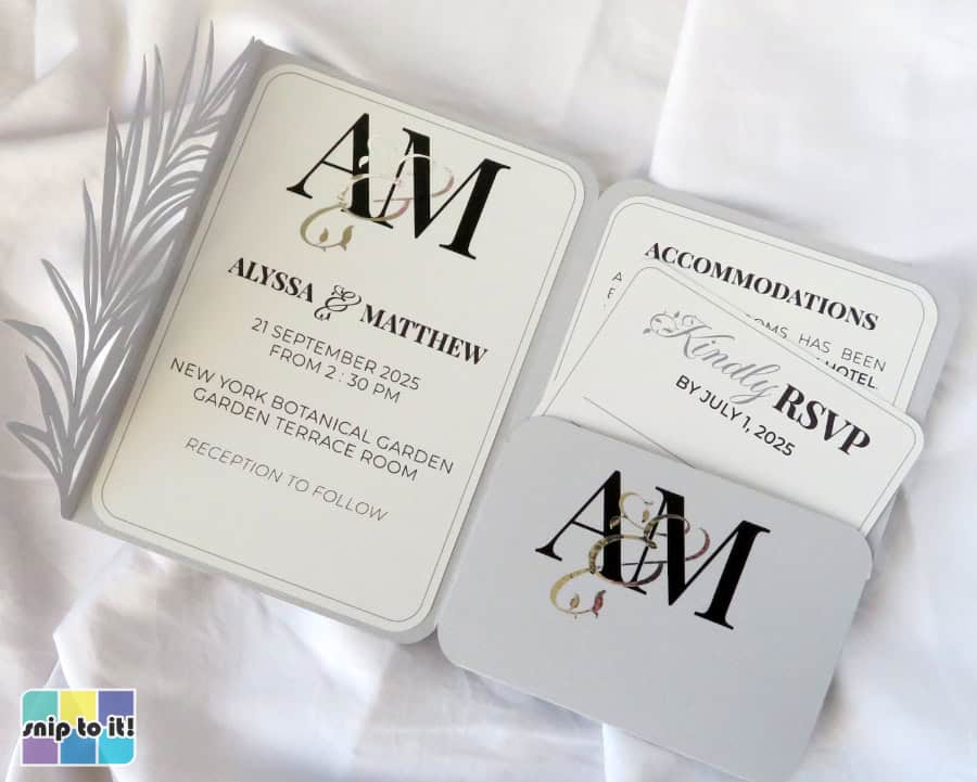 elegant portrait of the finished wedding invitation project highlighting the interwoven monogram on the invitation against a backdrop of white linens