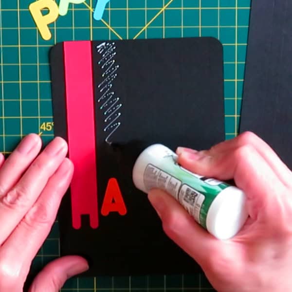 photo of card construction, adding glue to the card base within the scored guidelines, then lacing the cardstock piece on top