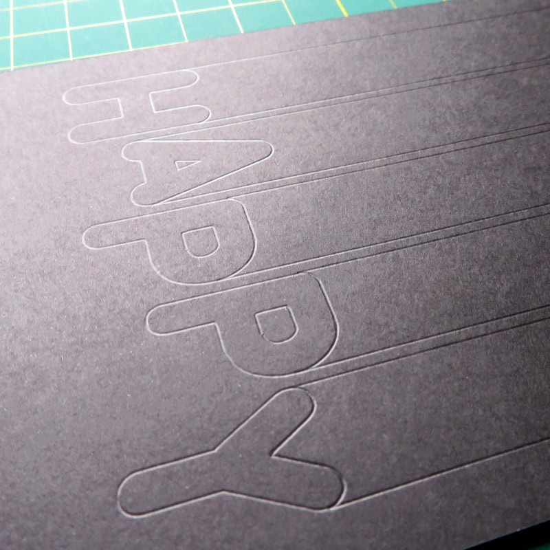 photo of front base panel of rainbow birthday card showing scored guidelines for design placement