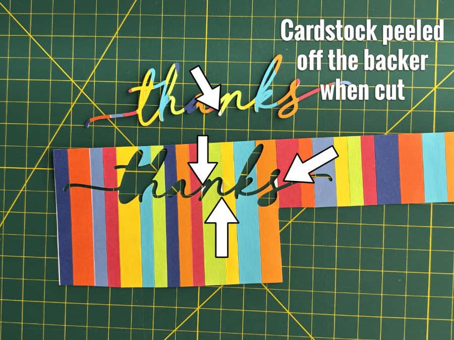 photo of custom striped cardstock made by gluing strips of cardstock to a plain cardstock base. When the striped cardstock was cut, small pieces of the stripes came off because they were not fully adhered to the cardstock base.