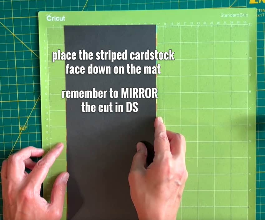 photo of placing the custom striped cardstock on the mat for cutting. The striped panel is flipped over so it will be cut from the back
