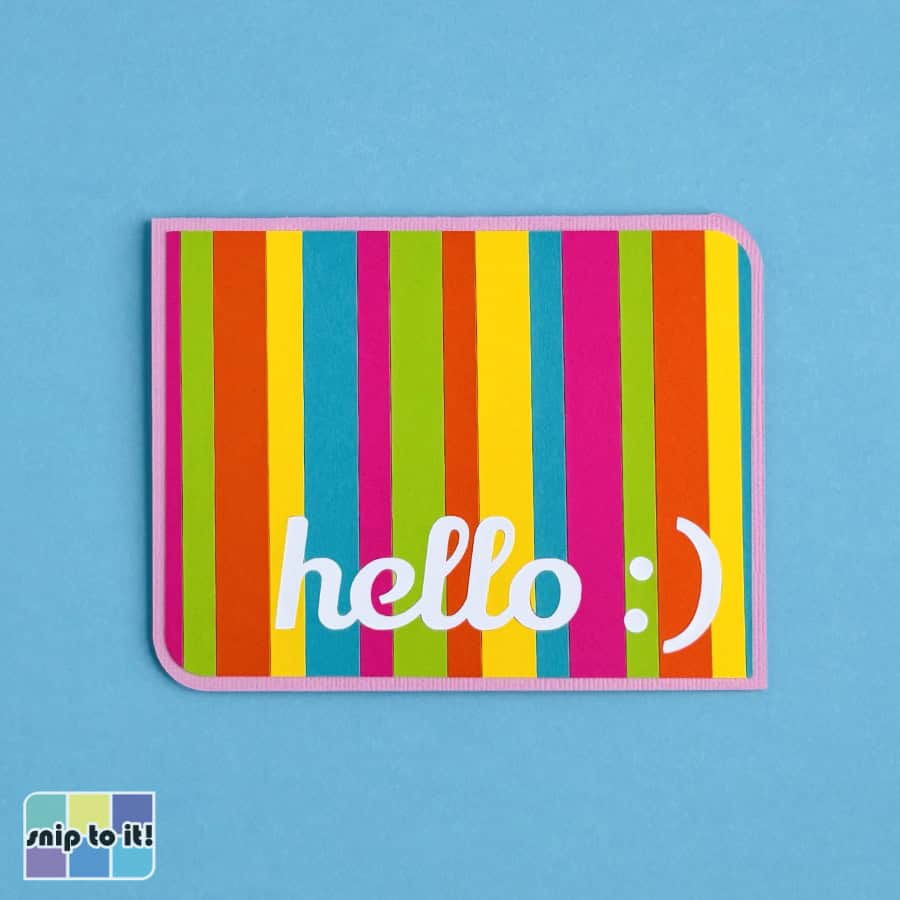 photo of completed inlay card with white text inlaid into a striped front panel on a pink base