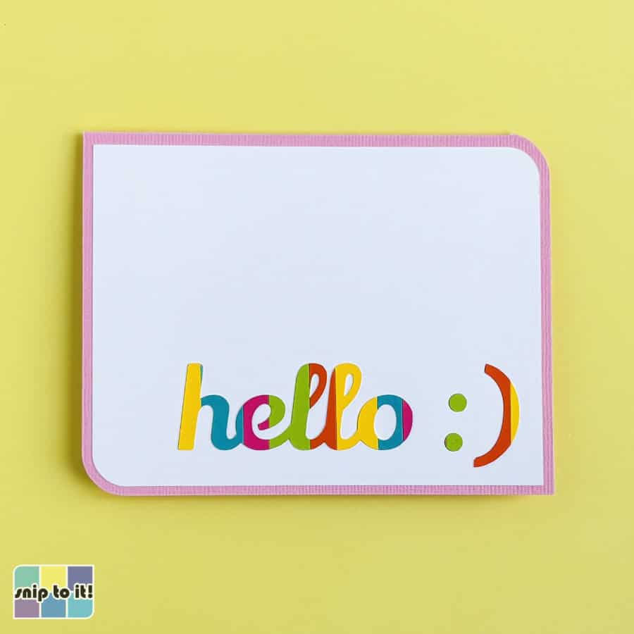 photo of finished inlay card with striped text inlaid into a white front panel on a pink card base