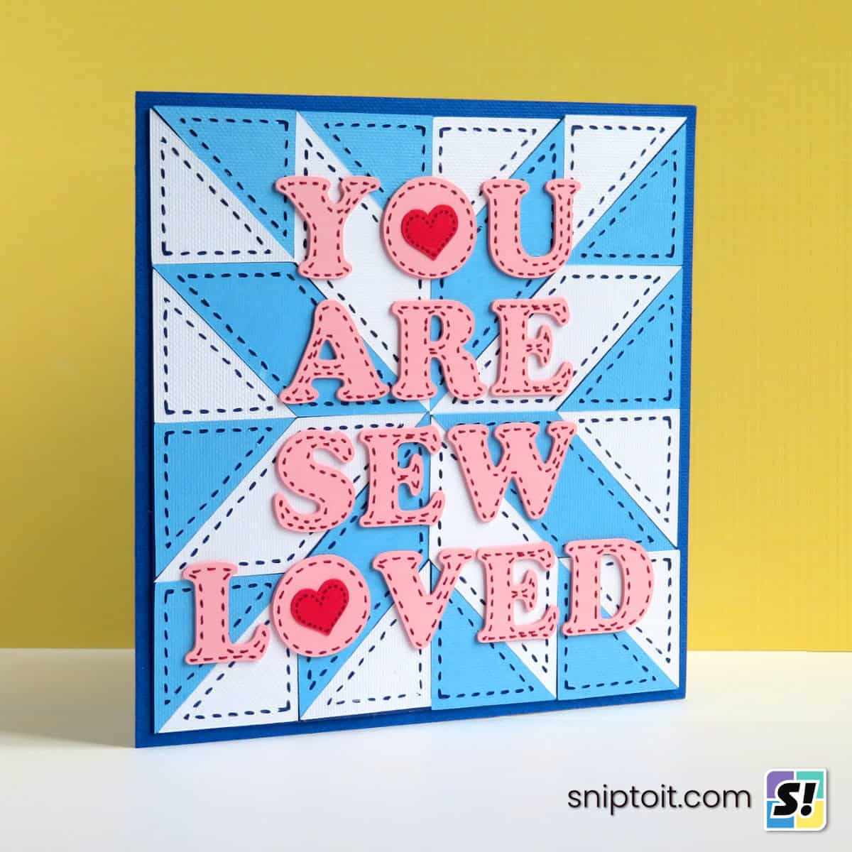 Cricut Stitch line hack feature image, showing a closeup of a homemade card decorated with faux stitching cut and drawn with a Cricut machine