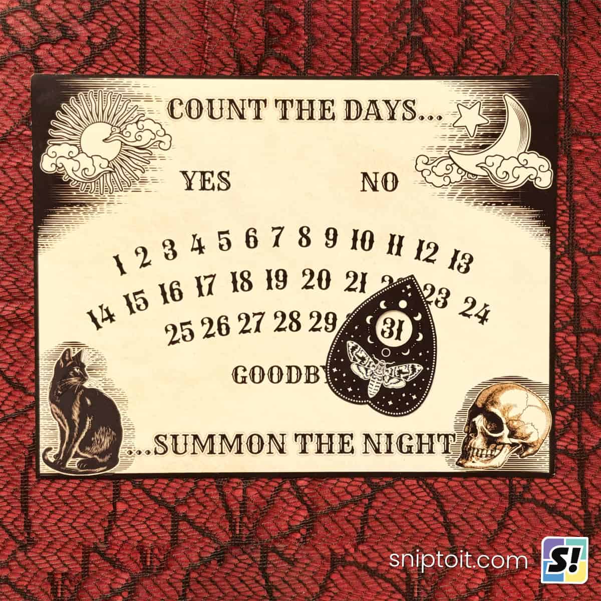 ouija inspired countdown calendar printed on an oversized magnet sheet, photographed on a red and black lace background