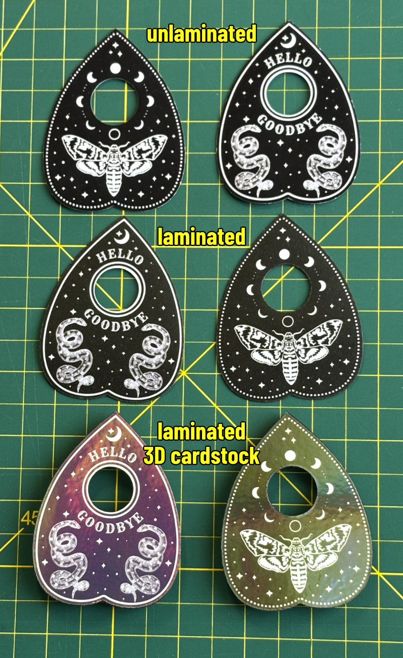photo of 3 sets of finished planchette magnets: unlaminated pair, laminated pair, and laminated pair made with cardstock and a craft magnet