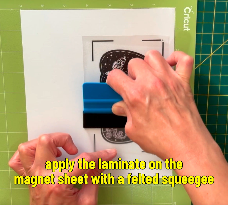 photo of applying matte laminate overlay onto printed magnet sheet