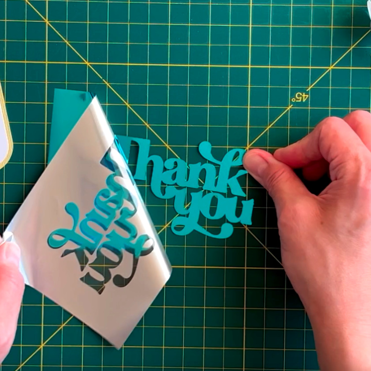photo of foiling adhesive cardstock Thankyou lettering using turquoise Cricut foil sheet