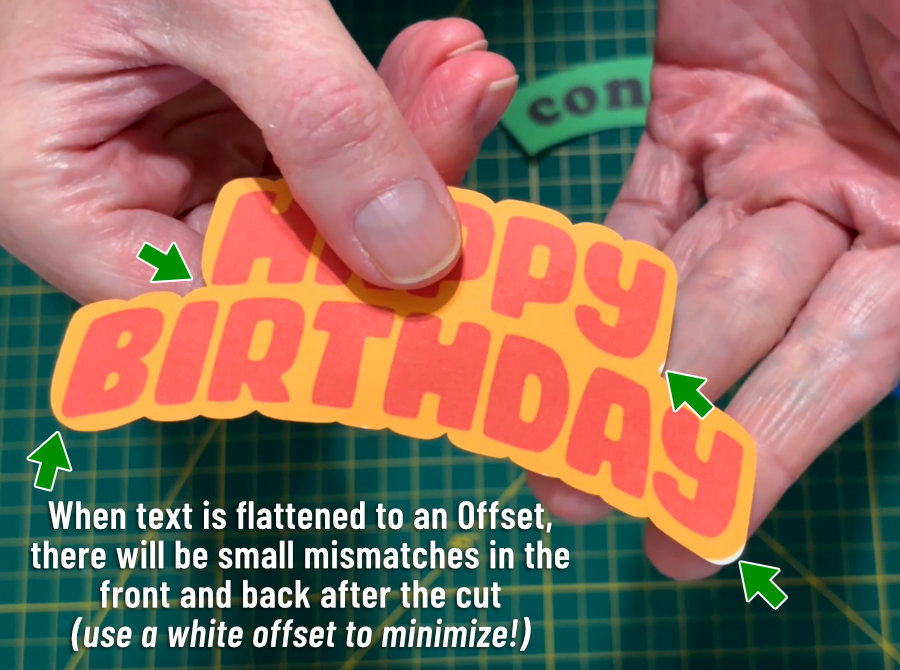 photo of finished 2-sided HAPPY BIRTHDAY text print & cut, showing small areas where the offset from the front was cut off due to mismatches with the back image/text (the back was used for the cut line)