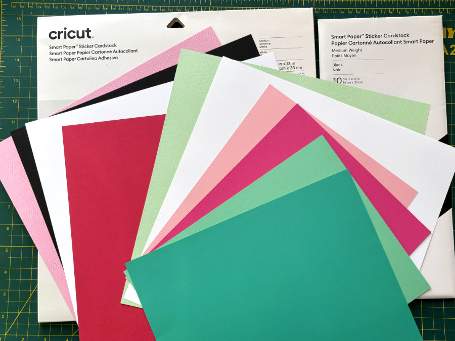 a collection of pink, green, red, black and white cardstock that will be used to make an inlay Christmas card