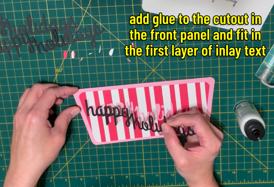 image of the first layer of inlay text being placed into the cut space inside the front card panel