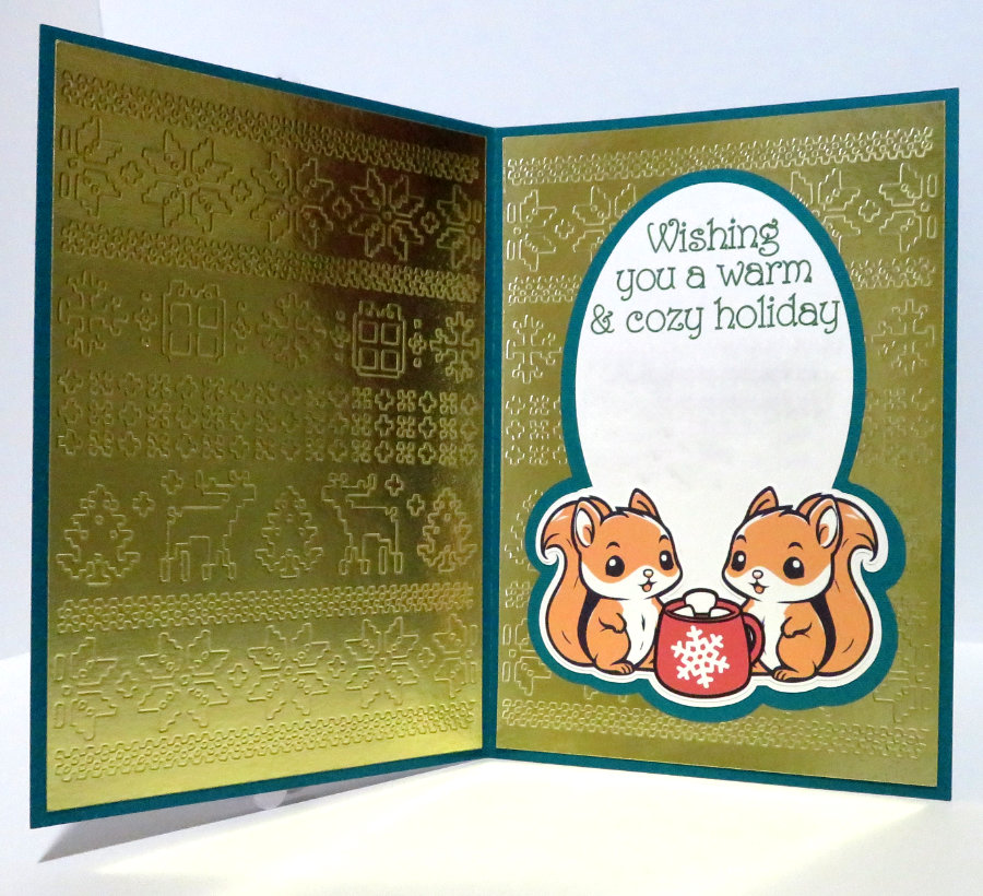 christmas card interior using the single line font SLF Pinwheel. Features two squirrels sharing a cup of cocoa, and the caption reads Wishing you a warm & cozy holiday