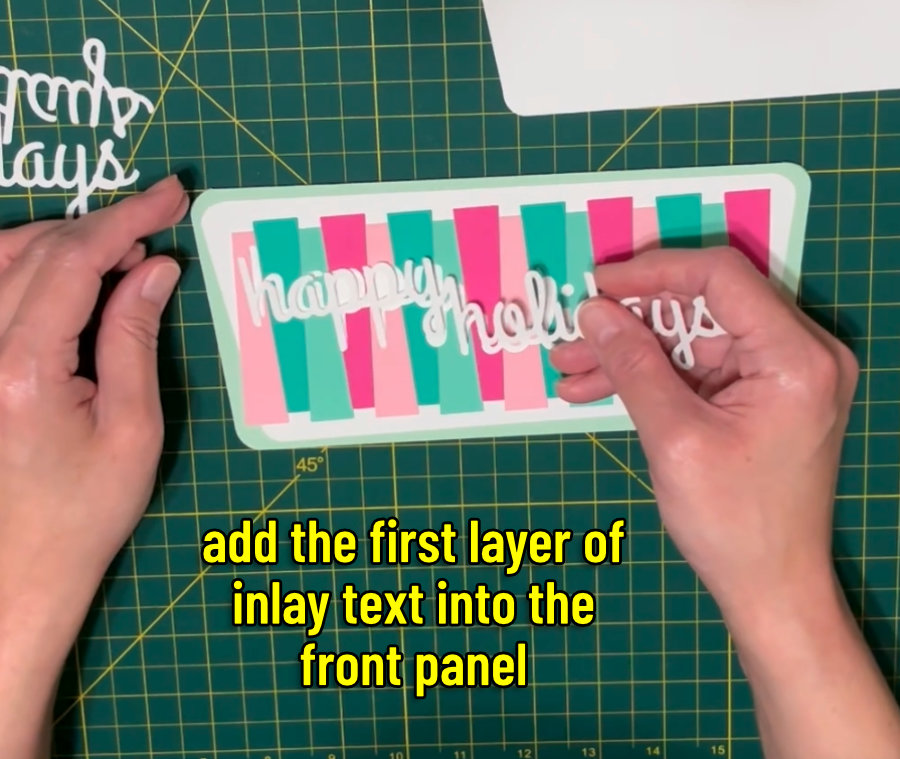 image of the first layer of inlay text being added to the front panel of the mid-century themed christmas card