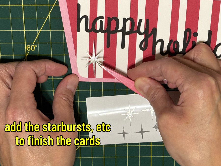 closeup image of a starburst cut out of shimmer vinyl being applied to the finished card with a pair of tweezers