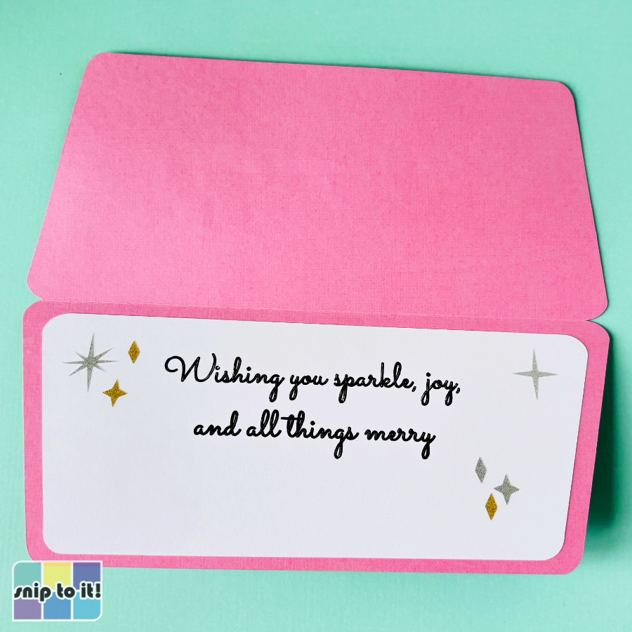 Bright pink Christmas card interior with a cheerful sentiment inside reading "Wishing you sparkle, joy, and all things merry". Embellished with silver and gold sparkle stars and diamonds
