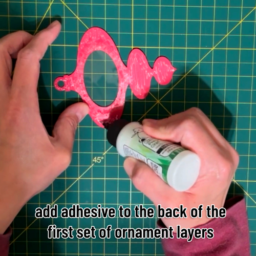 glue being applied to the remainder of the ornament backside in preparation for both sides being stuck together