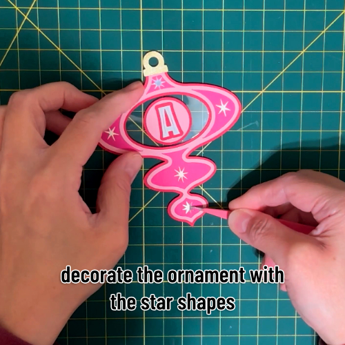 the ornament is finished by applying gold and silver stars cut out of shimmer vinyl