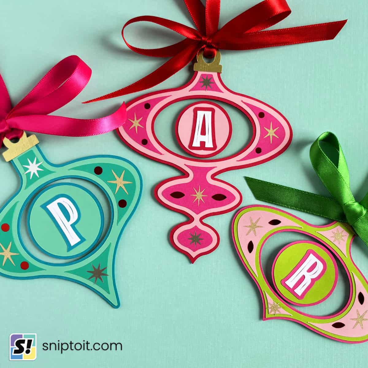 image showing three mid century modern style monogrammed christmas ornaments