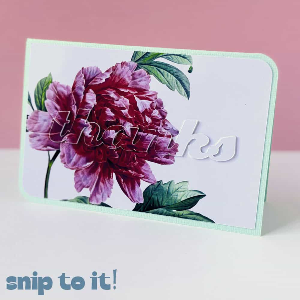 photo of completed eclipse card made using a flattened image of a pink peony on a white panel. Card was made using the easy method - top printed text was Attached to the printed panel and physically cut using the Cricut Maker. Finished card is shown, with the front panel affixed to a pastel green card base in landscape orientation
